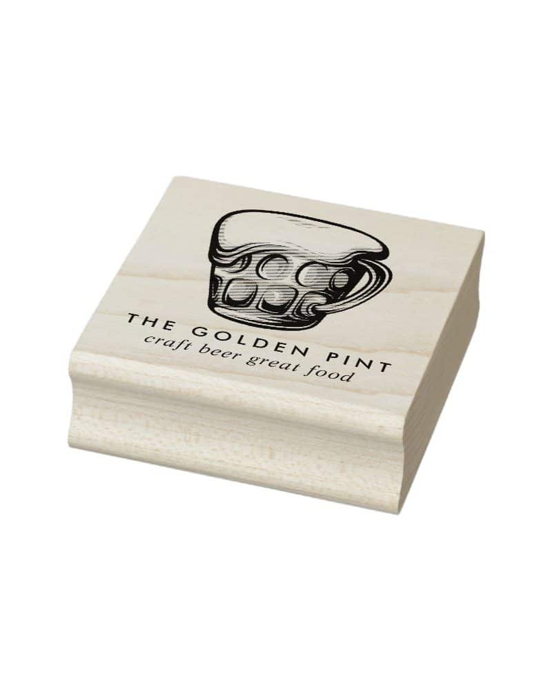 Wooden stamp featuring a beer mug graphic and the text The Golden Pint craft beer great food.