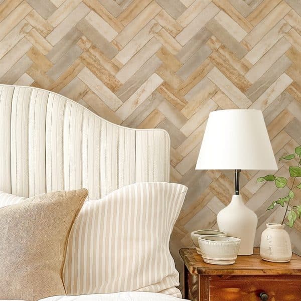 Beige And Tan Striped Headboard With Matching Pillows Against A Herringbone Patterned Wall.