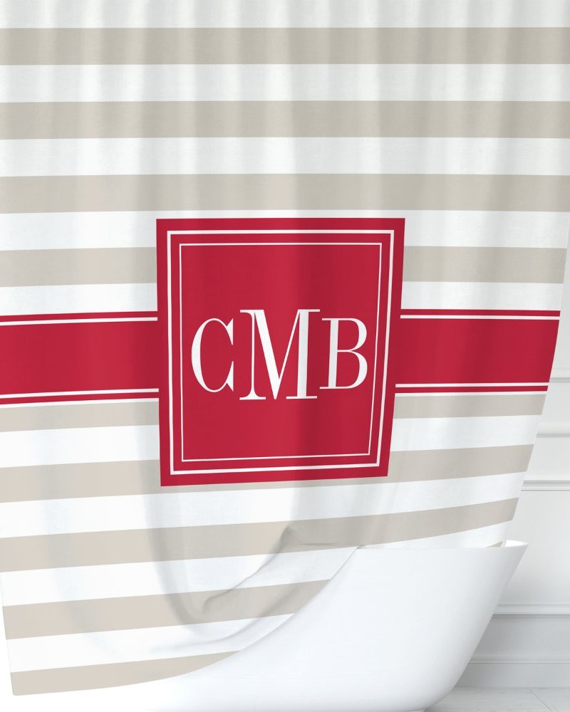 Beige and white striped shower curtain with a red square monogram CMB.