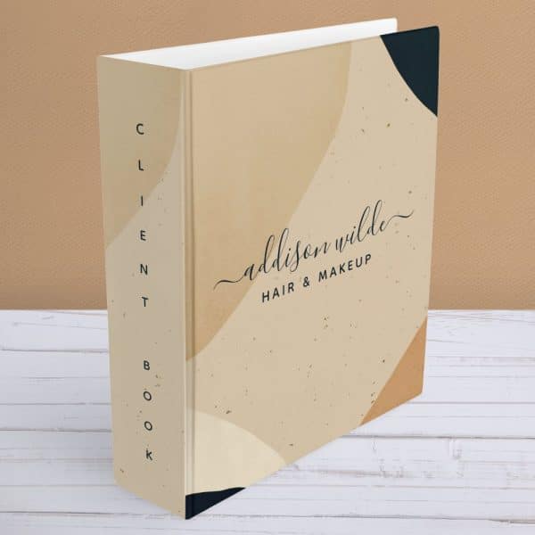 Beige Client Book With Abstract Shapes And Addison Wilde Hair &Amp; Makeup Written On The Cover.