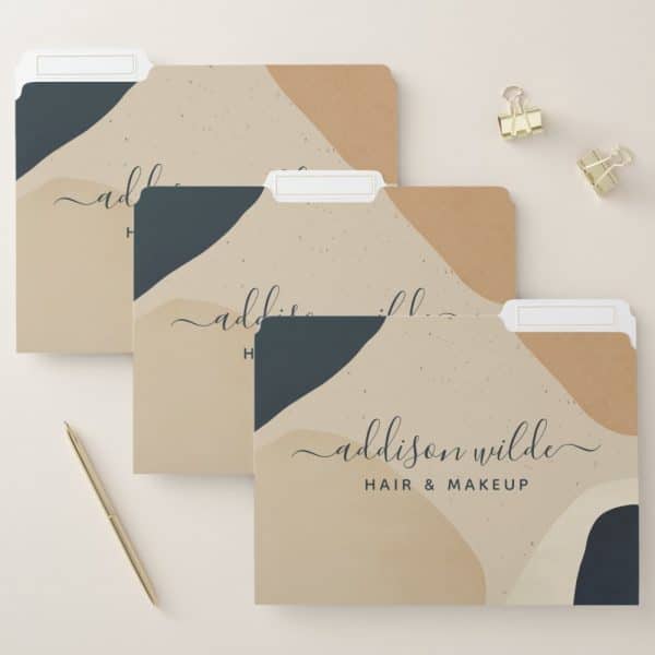 Three File Folders With An Abstract Design In Beige And Dark Blue, Featuring The Name Addison Wilde Hair &Amp; Makeup In Elegant Script.