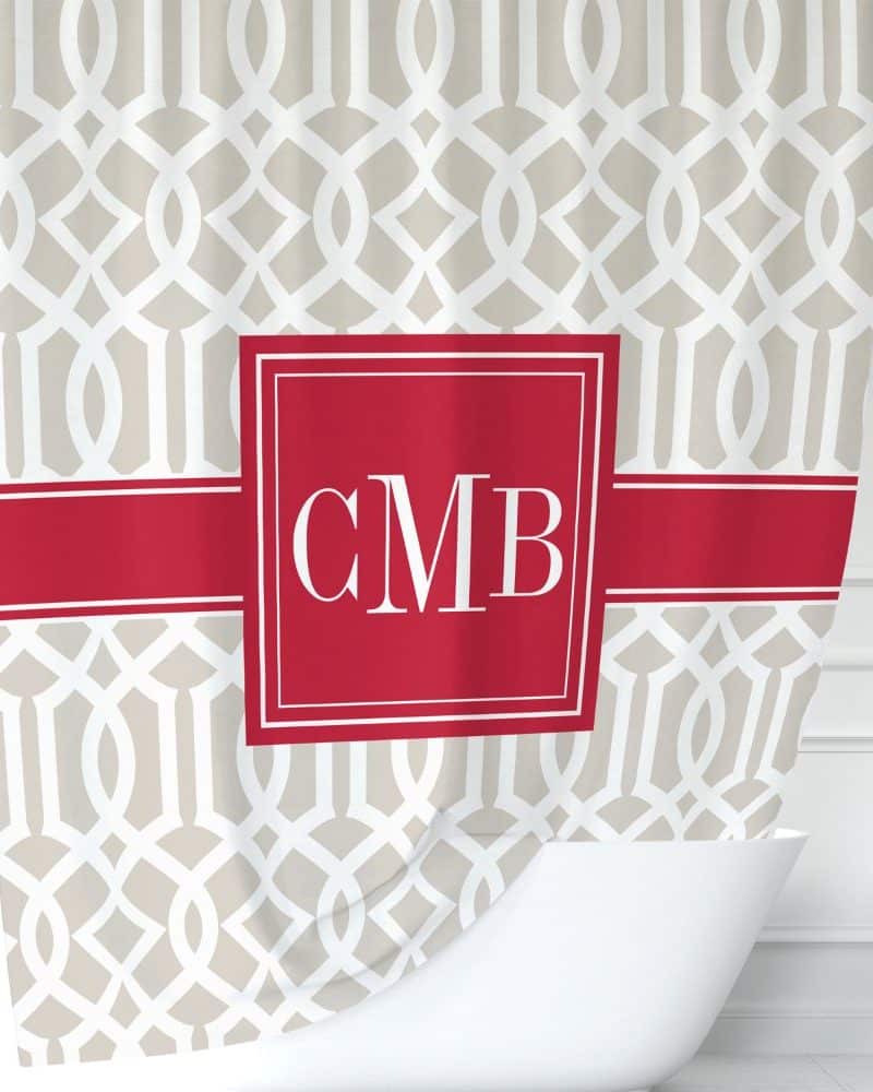 Beige shower curtain with a red band and monogram CMB.