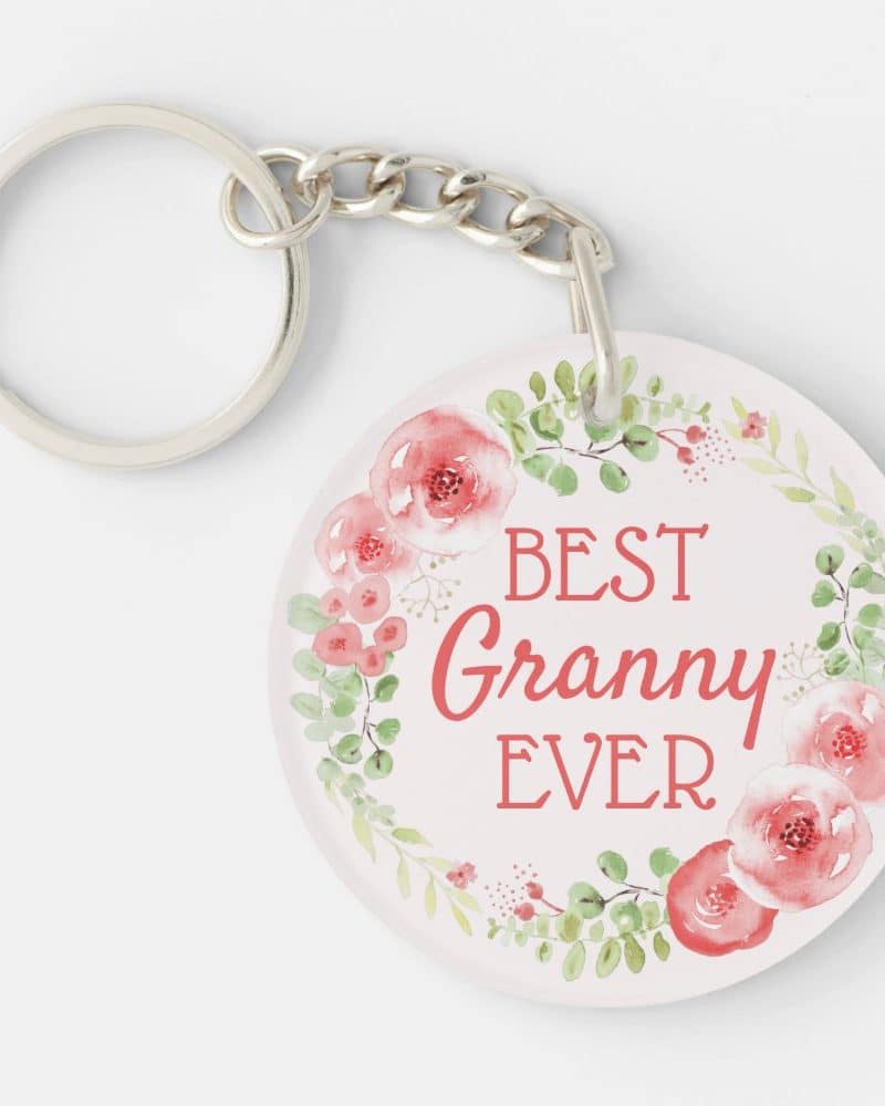 Round keychain with a floral wreath design and the text Best Granny Ever.