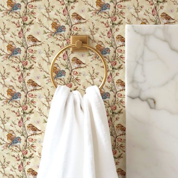 White Towel Hanging On A Gold Ring Against A Floral Wallpaper Featuring Birds And Roses.