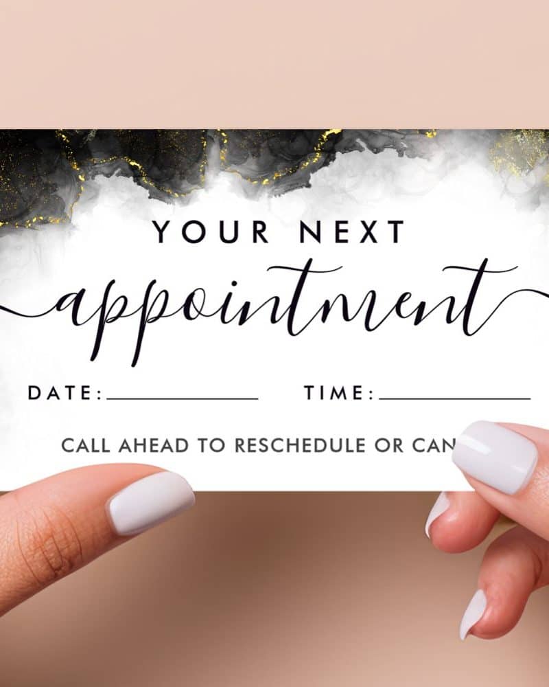 Appointment reminder card with black, white, and gold marble design. Spaces to fill in date and time. Instruction to call ahead to reschedule.