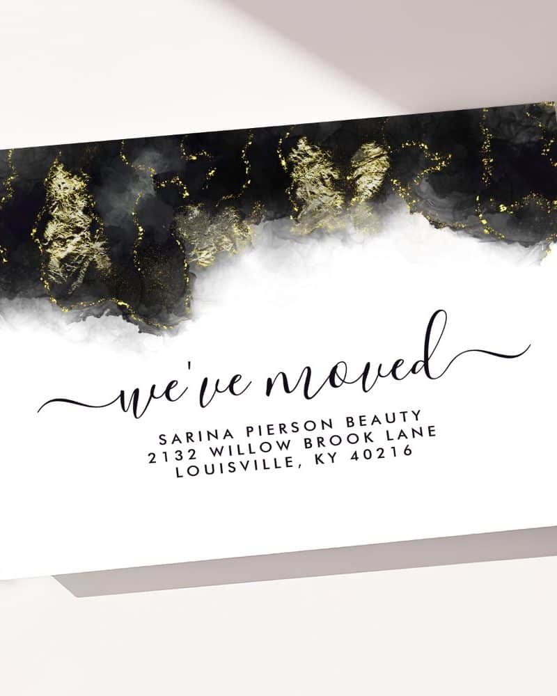 A black and gold moving announcement card.