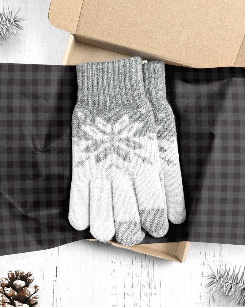 Pair of gray and white knit gloves with snowflake pattern, in a gift box.