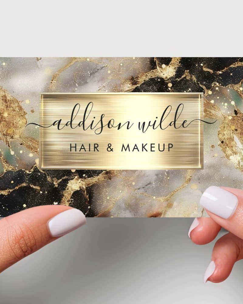 Business card with gold and black marble design, featuring the name Addison Wilde Hair & Makeup.