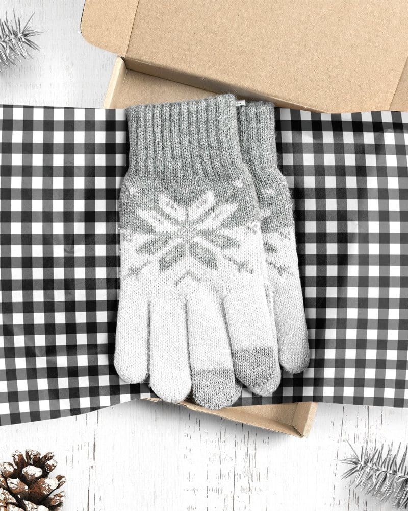 Pair of gray and white knit gloves with snowflake pattern in a gift box.