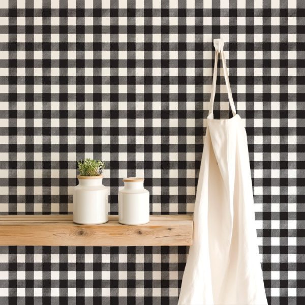 Black And White Buffalo Check Wallpaper With A Wooden Shelf Holding Two White Containers And A White Apron Hanging On A Hook.