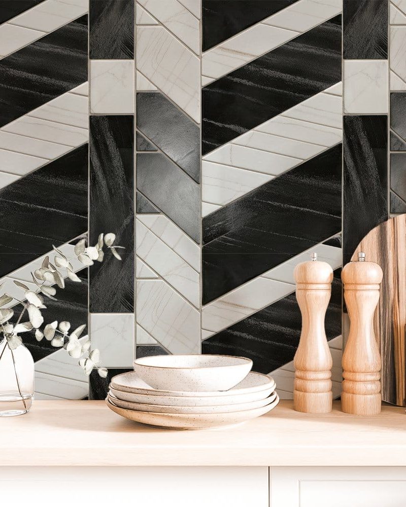 Black and white geometric tile backsplash with kitchenware.