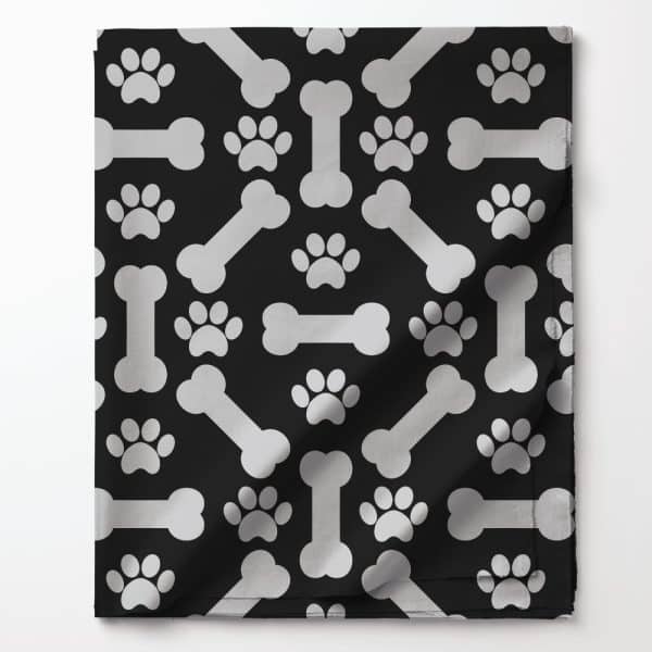 Black Fabric With A Repeating Pattern Of Silver Bones And Paw Prints.