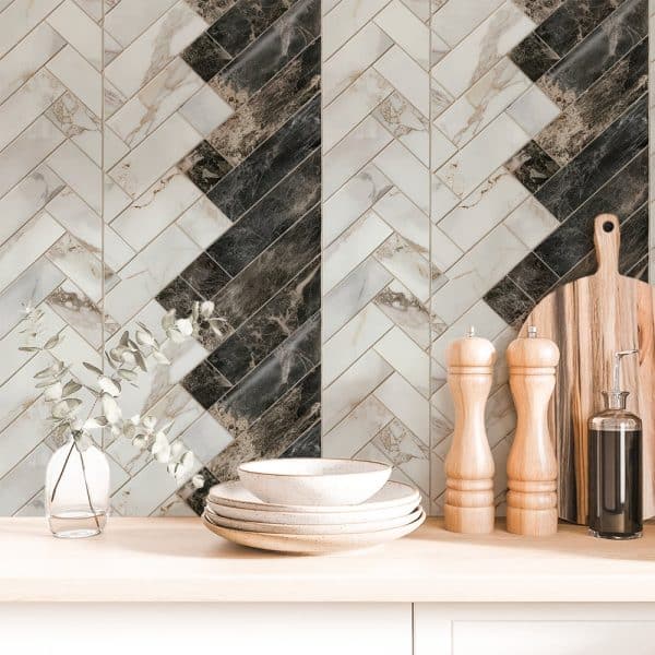 Herringbone Marble Tile Backsplash With Stacked Dishes And Kitchen Utensils.