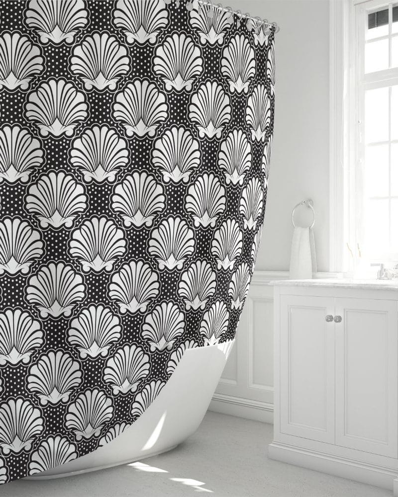 Black and white shower curtain with a repeating seashell pattern.