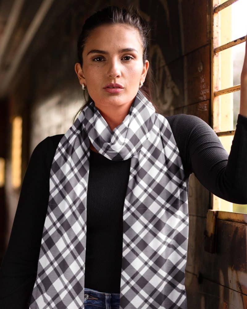 Woman wearing a black and white plaid scarf.