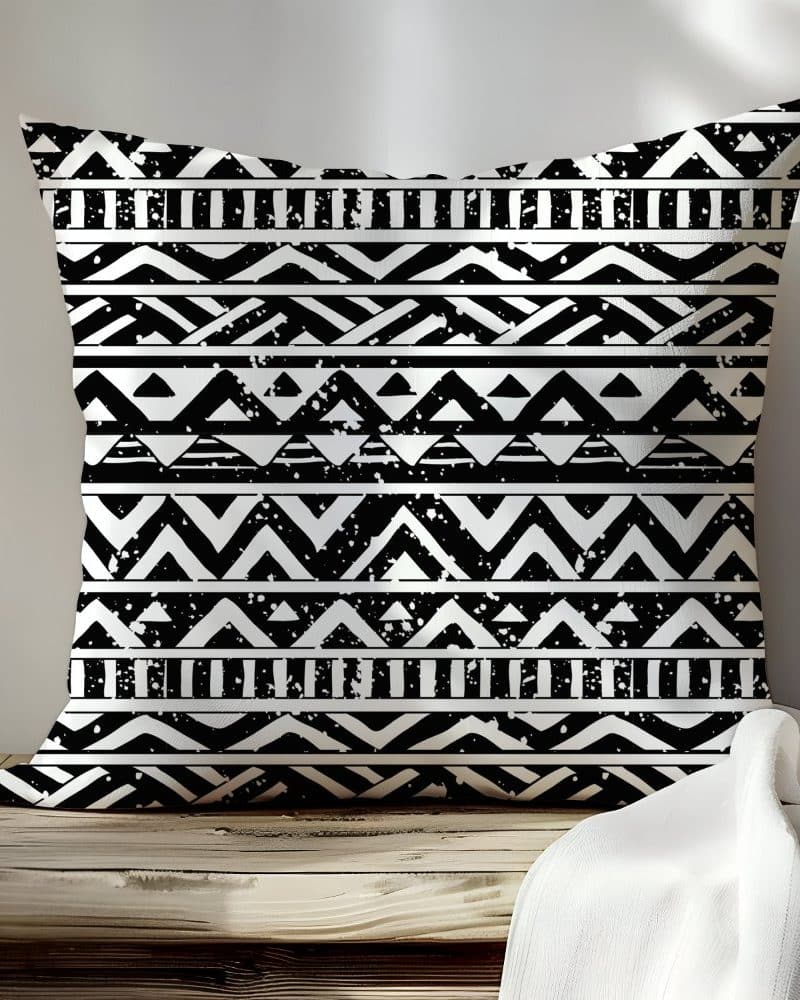 Black and white patterned throw pillow with geometric designs.