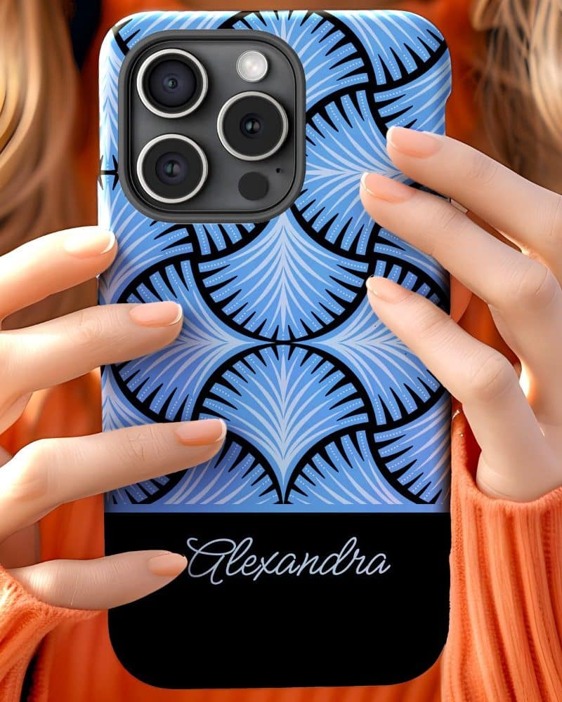 Person holding a phone case with a blue and black geometric pattern and the name Alexandra.