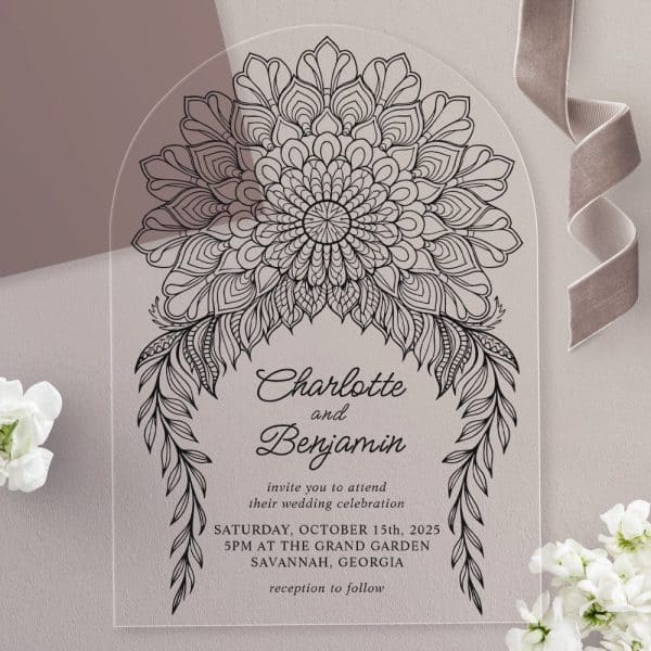 Clear Acrylic Wedding Invitation With A Black And White Mandala Design And The Names Charlotte And Benjamin.