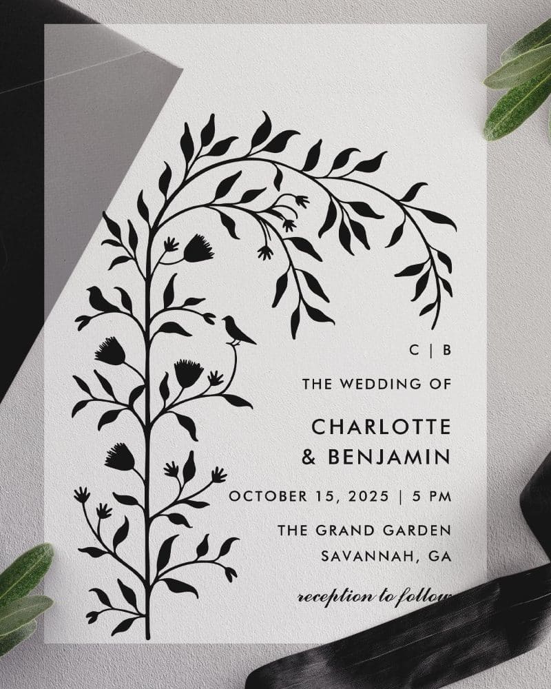 Wedding invitation with black floral illustration and wedding details.