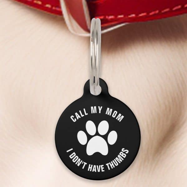 Black Pet Id Tag With A Paw Print And The Text: Call My Mom, I Don'T Have Thumbs.