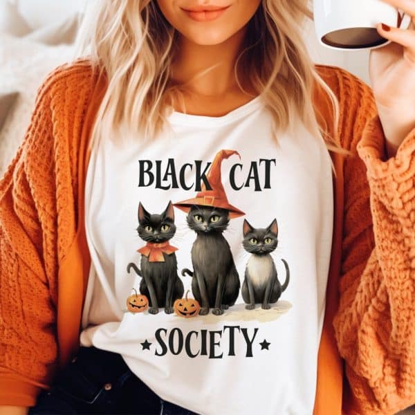 Woman Wearing A White T-Shirt Featuring Three Black Cats And The Text Black Cat Society.