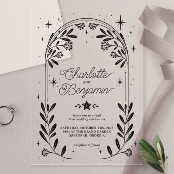 Clear Wedding Invitation With Black Floral Arch And Names Charlotte And Benjamin. Date And Location Details Are Included.