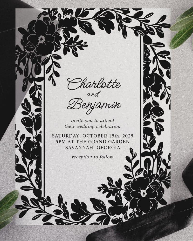 Black and white wedding invitation with floral border; Charlotte and Benjamin's names are prominently displayed.
