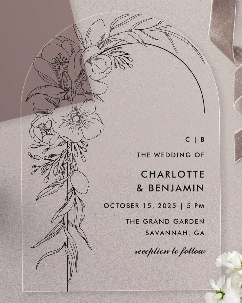 Arch-shaped clear acrylic wedding invitation with black line floral design and wedding details for Charlotte and Benjamin.