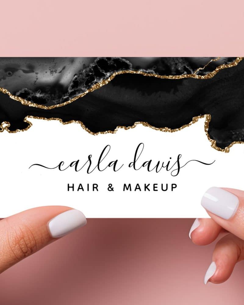 Black and gold glitter business card for Carla Davis Hair & Makeup.