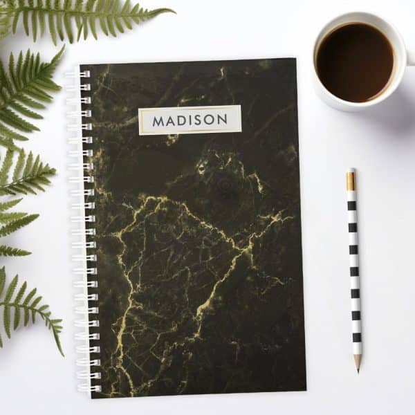 Black Marble Notebook With The Name Madison On The Cover.