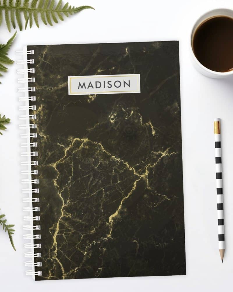Black marble notebook with the name Madison on the cover.