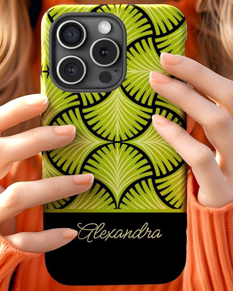 A person holds a lime green and black phone case with the name Alexandra on it.