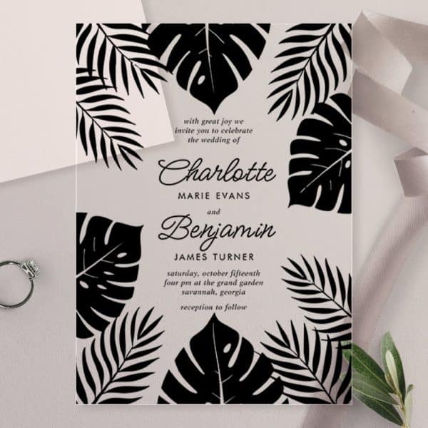 A Wedding Invitation With Black Tropical Leaves On A White Background Announcing The Marriage Of Charlotte Marie Evans And Benjamin James Turner.