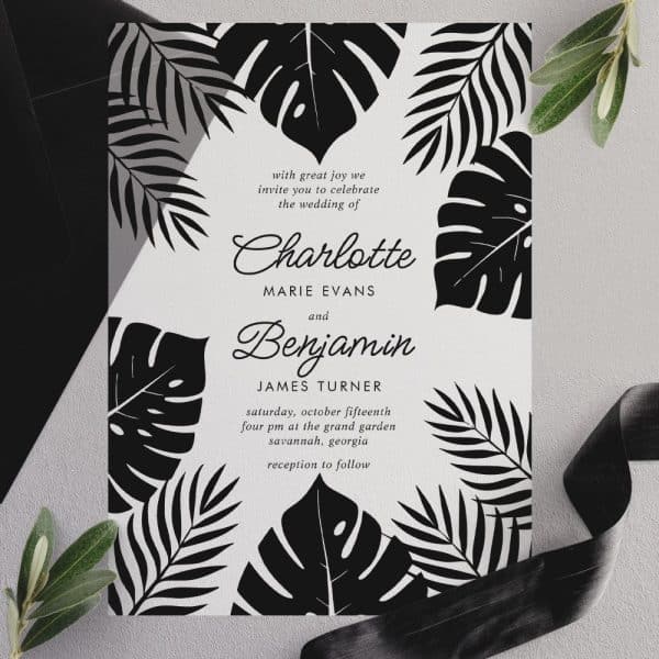 Black And White Wedding Invitation Featuring Tropical Leaves And Announcing The Marriage Of Charlotte Marie Evans And Benjamin James Turner.