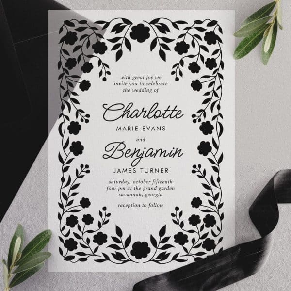 Black And White Wedding Invitation With Floral Border Featuring The Names Charlotte And Benjamin.