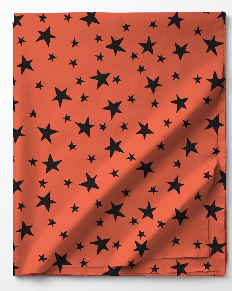 Coral fabric with a pattern of black stars.