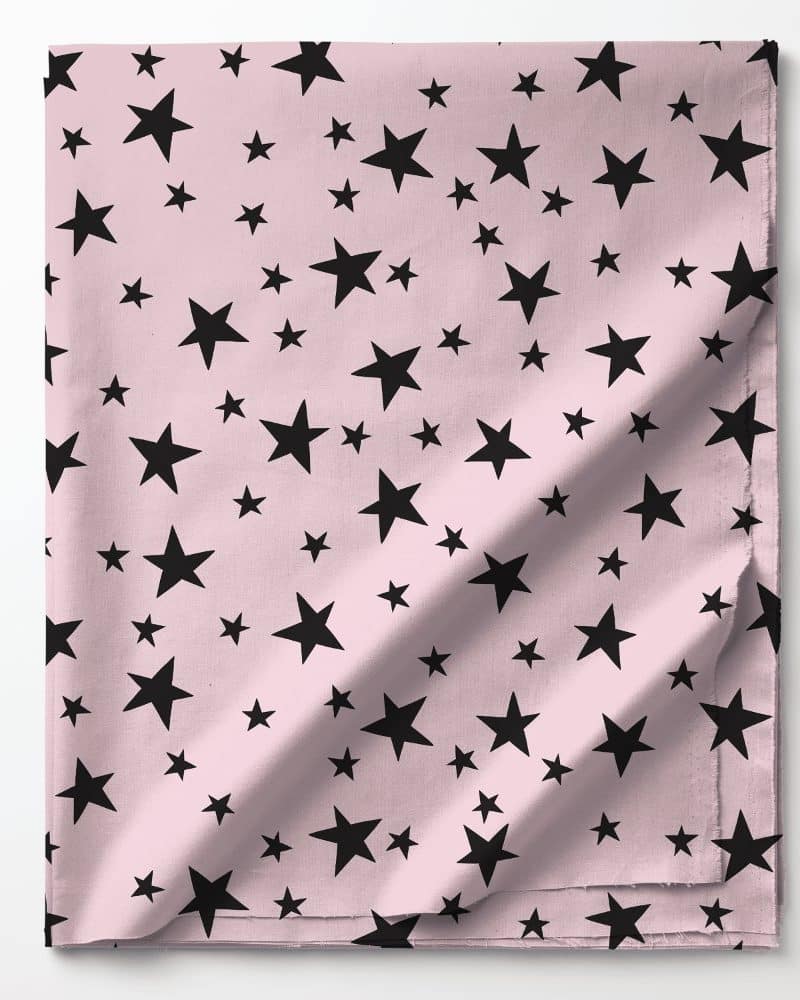 Pink fabric with a repeating pattern of black stars.