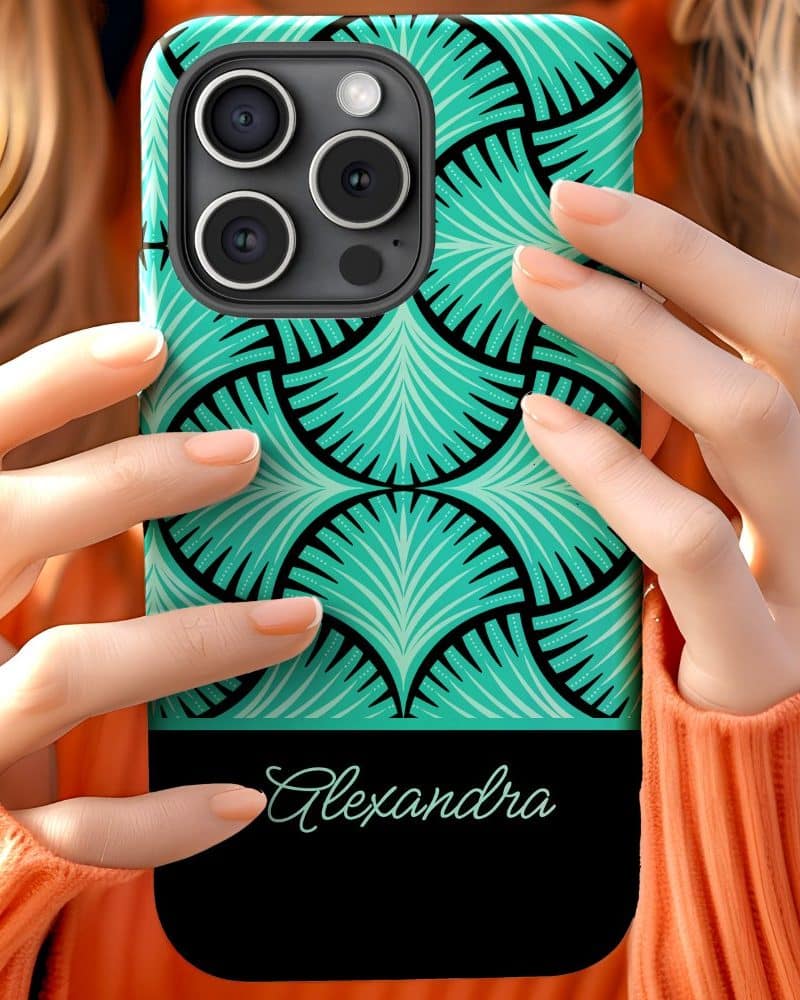 Two hands hold a teal and black phone case with the name Alexandra on it.