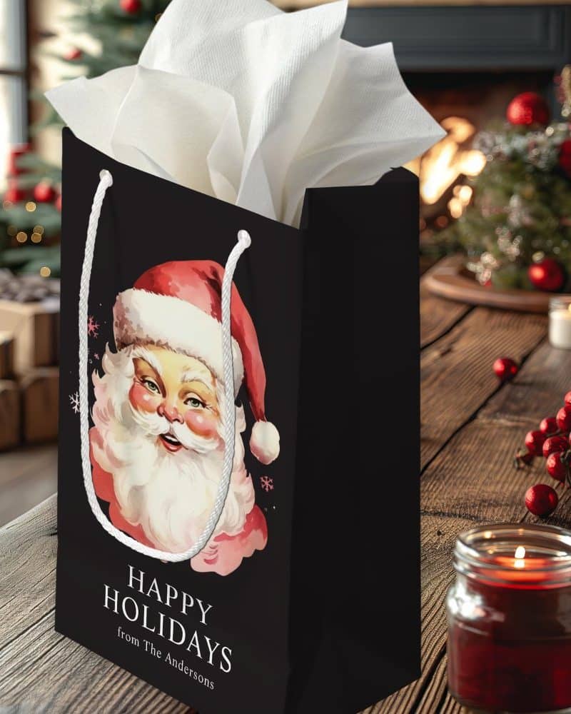 Black gift bag with a vintage Santa Claus illustration, "Happy Holidays" text, and a personalized sender's name.