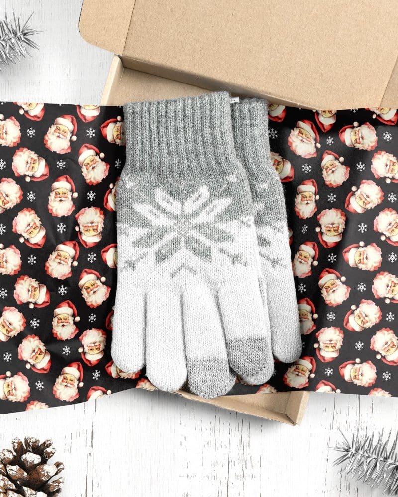 Pair of grey and white snowflake patterned gloves in a gift box.