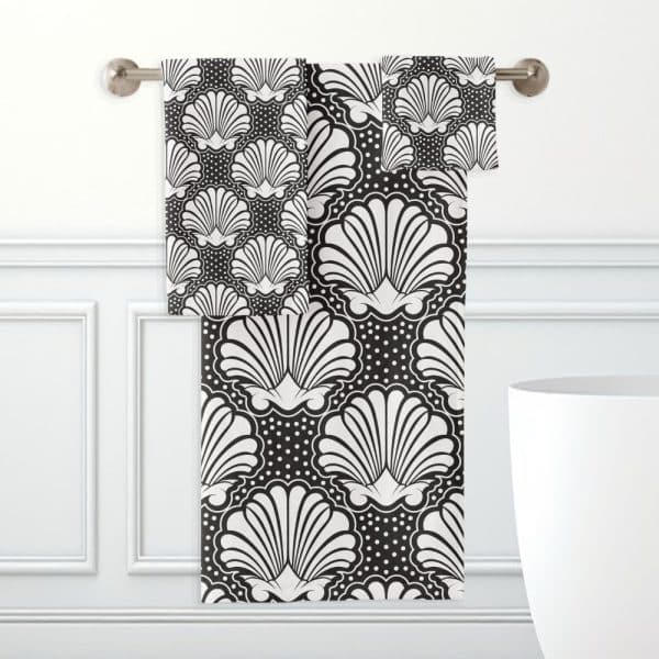 Black And White Bath Towels Hanging On A Rack, Featuring A Repeating Seashell Pattern.
