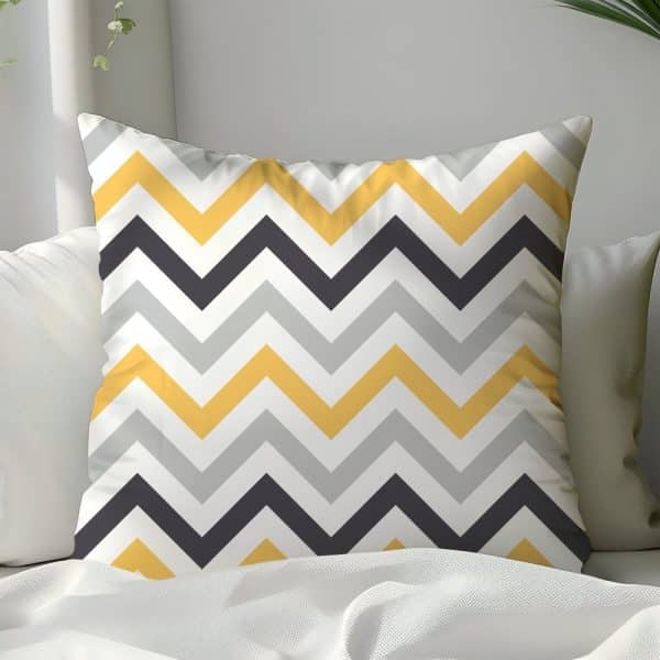 Decorative Pillow With Yellow, Gray, And Black Chevron Pattern.