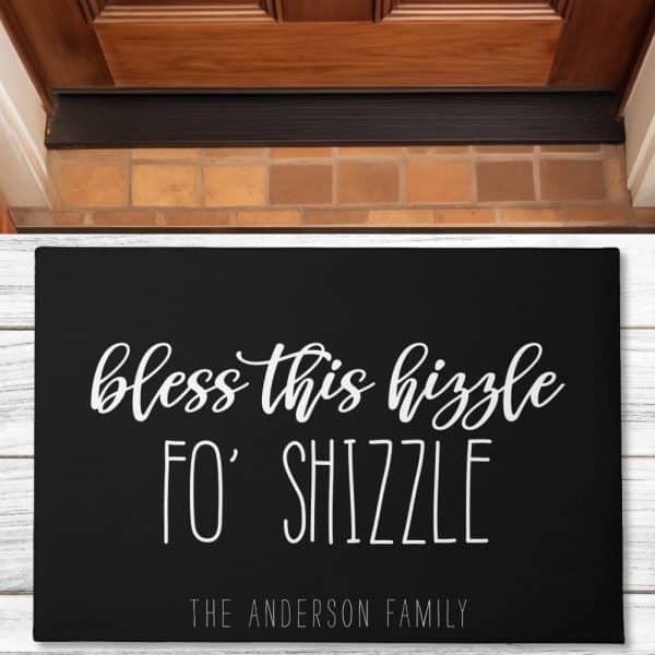 Black Doormat With White Cursive Text Reading Bless This Hizzzle Fo' Shizzle And The Anderson Family Name Below.