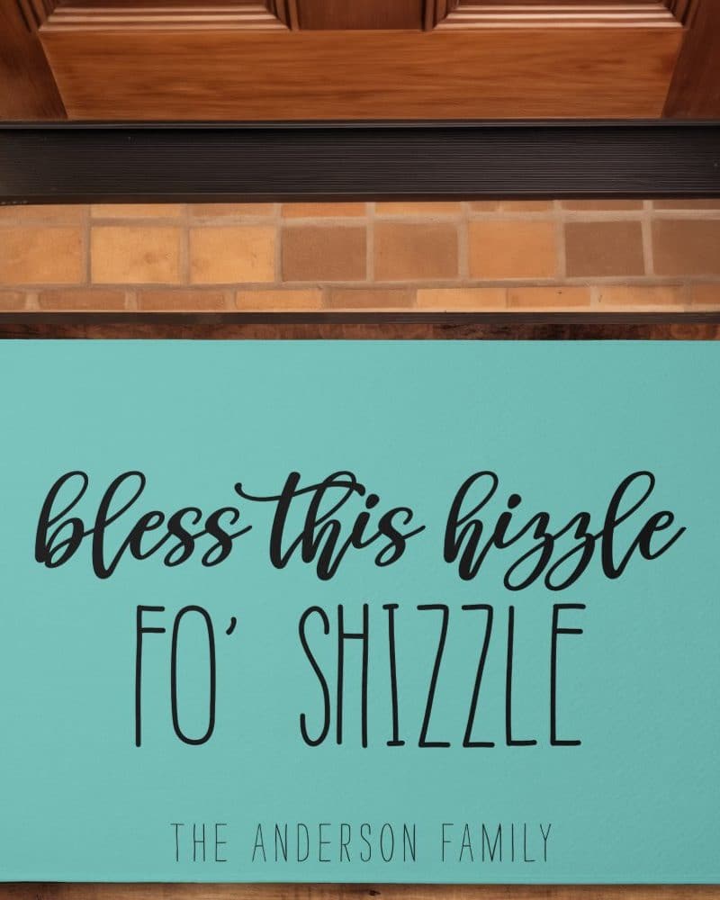 Teal doormat with the text Bless this hizzzle fo' shizzle and The Anderson Family.