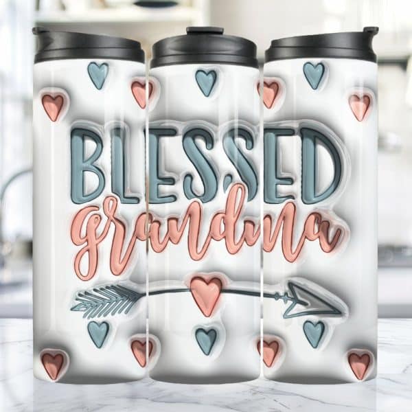 Three Travel Mugs With A White Background Featuring The Words Blessed Grandma In Peach And Teal Lettering, An Arrow, And Small Hearts.