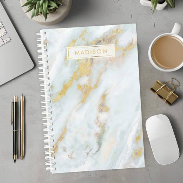 Spiral-Bound Notebook With A Light Blue Marble Cover And Gold Accents; The Name Madison Is Printed On The Cover.
