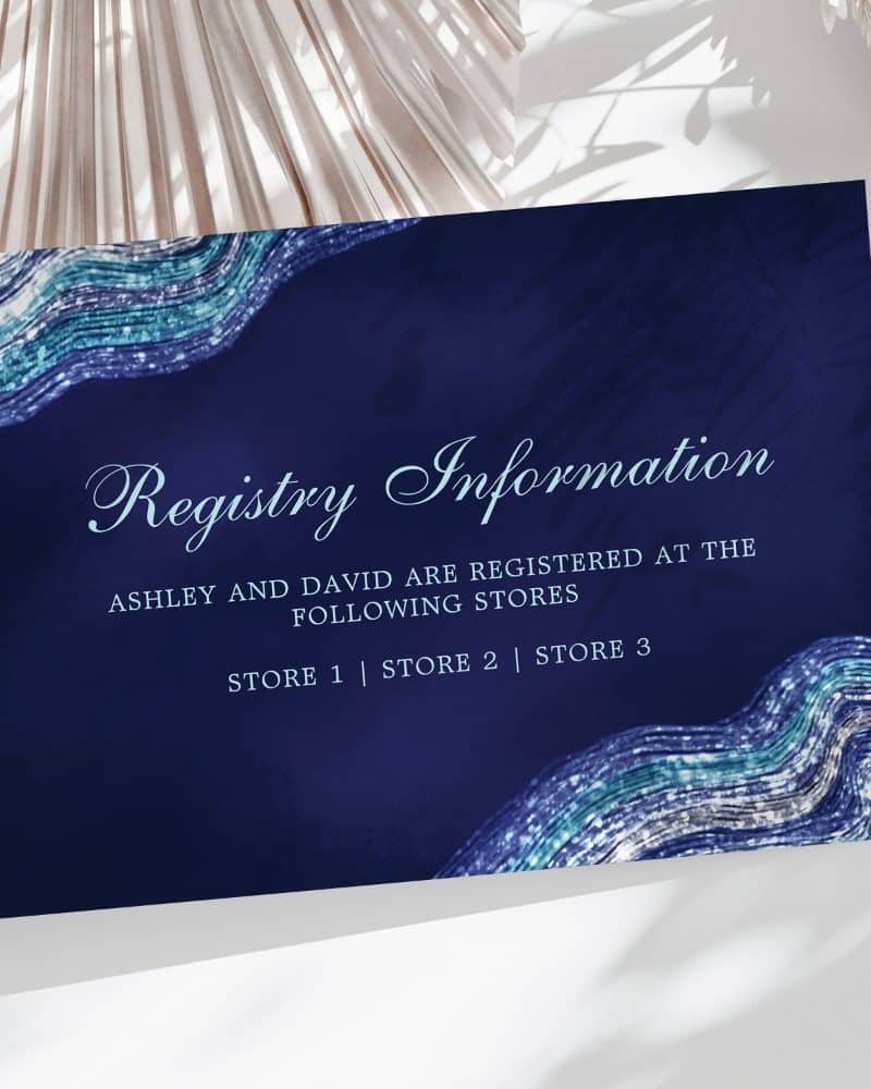 Navy blue registry card with teal and silver glitter wave design, showing Ashley and David's registry information.