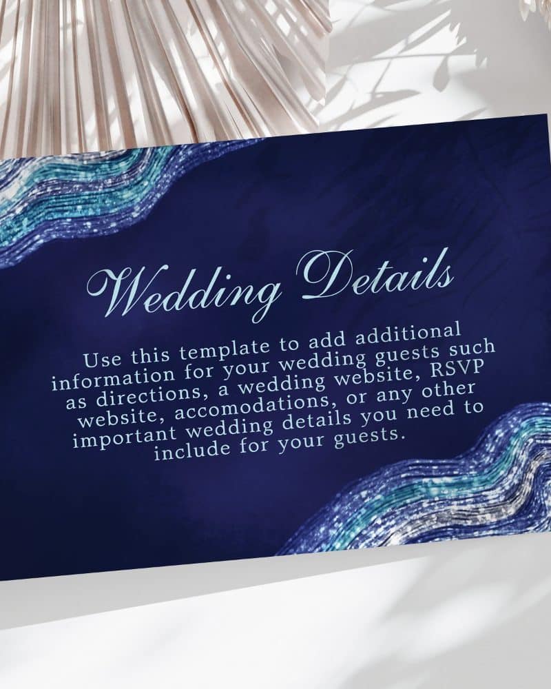 Navy blue wedding details card with teal and silver wave design.