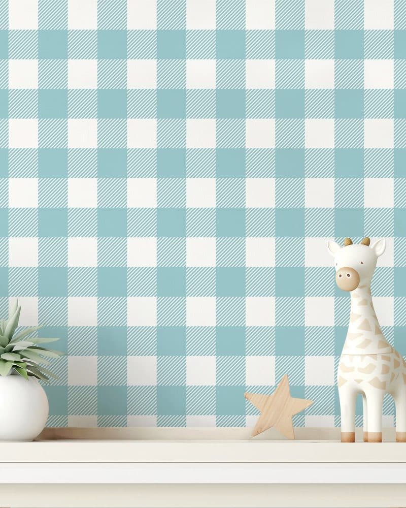 A white and light blue gingham pattern wall with a small giraffe and star on a shelf.