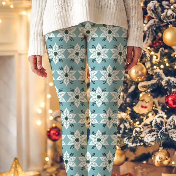 Light Blue Leggings With A Repeating Pattern Of White Poinsettias And Dark Green Leaves.